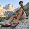 GUMBIES FRANCE brown flip-flops with a textured rubber sole and a cotton toe post. Features a leather strap with embossed logo.