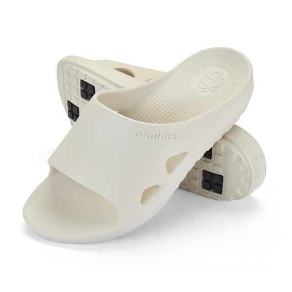 GUMBIES FRANCE cream-colored eco-friendly slides with contoured footbed and textured sole. Ideal for recovery and daily wear.