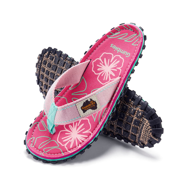 GUMBIES FRANCE Islander flip-flops in pink with hibiscus print, featuring a recycled rubber sole and natural cotton straps.