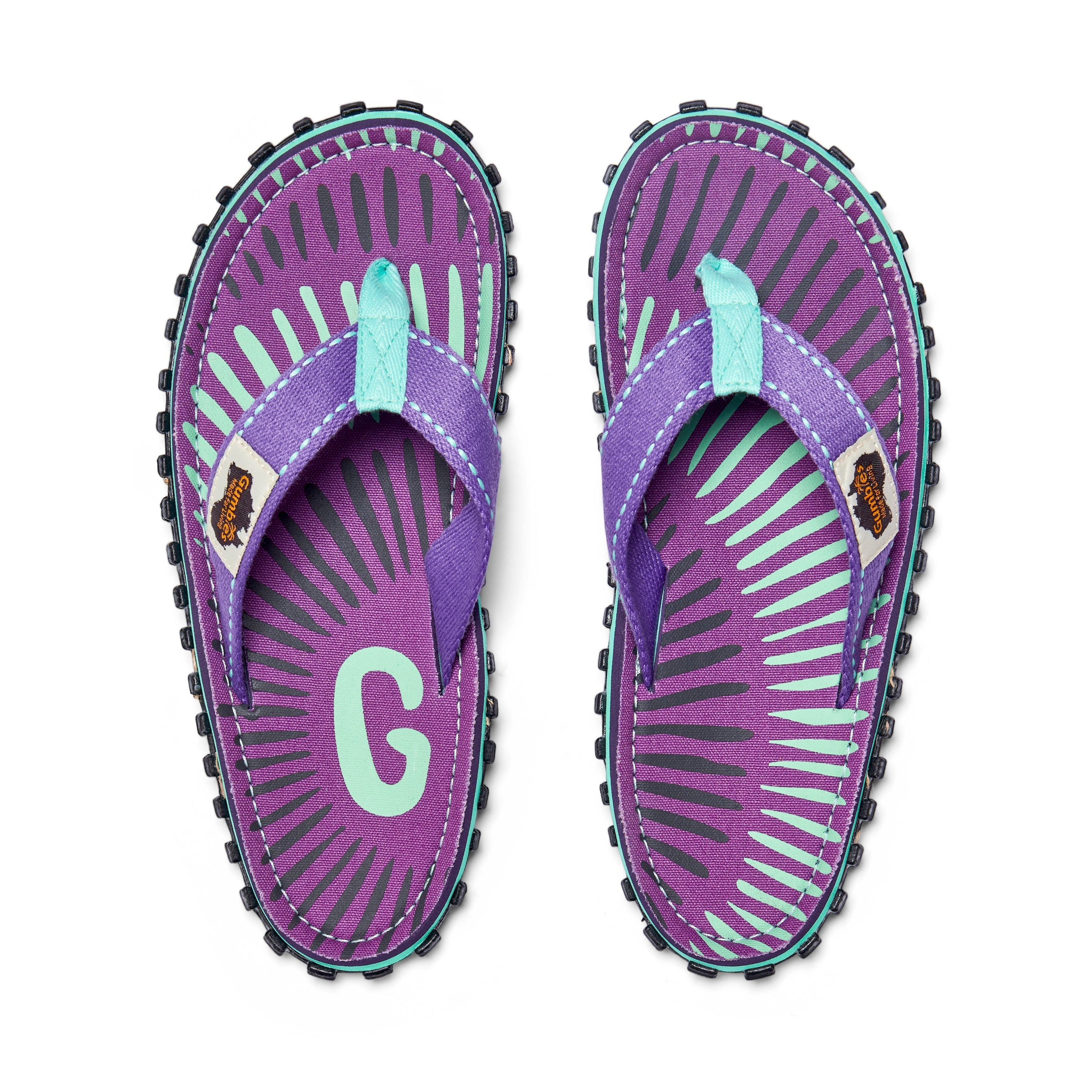 GUMBIES FRANCE Islander flip-flops with purple canvas, mint green and grey sunburst pattern, and mint green straps.