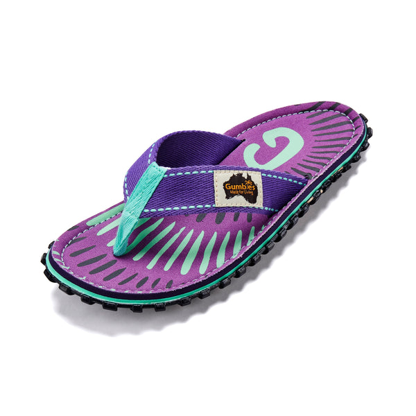GUMBIES FRANCE Islander flip-flops in purple with mint green and black abstract stripe pattern. Features a woven strap and durable sole.