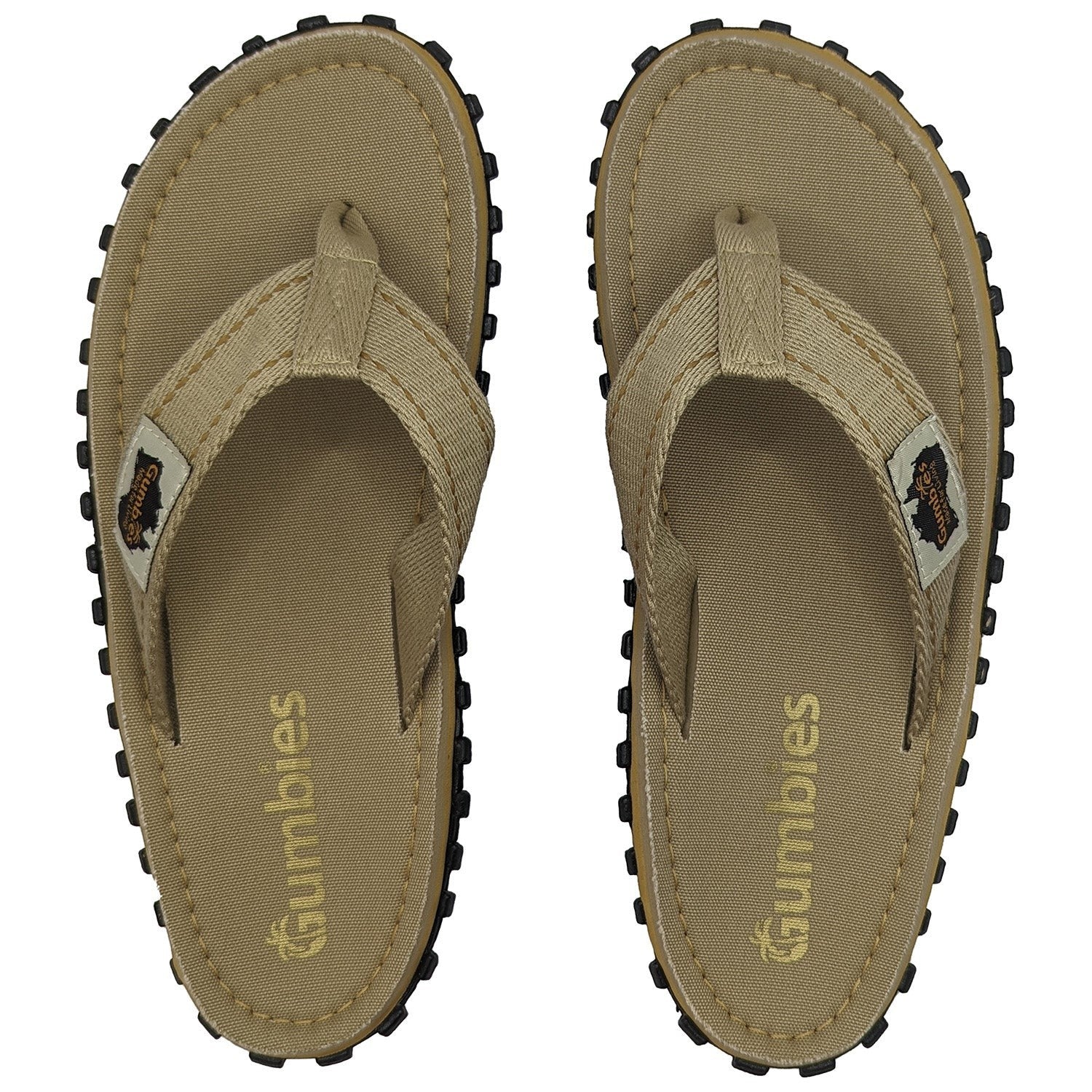 GUMBIES FRANCE tan canvas flip-flops for men and women with textured black soles and Gumbies branding.